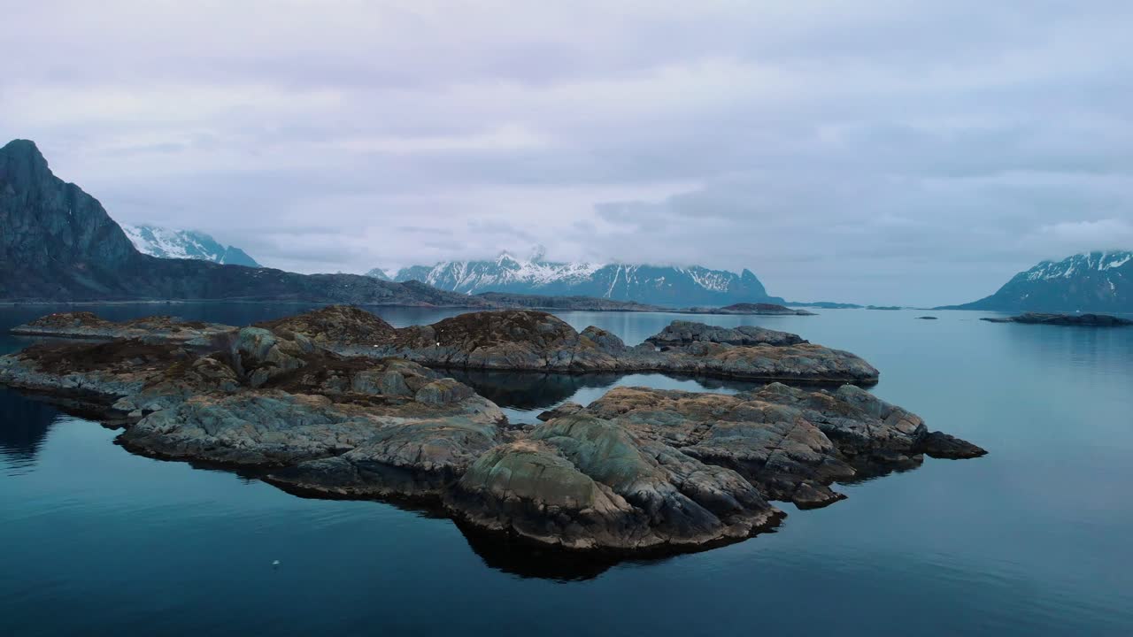 Dramatic aerial drone view of a foggy ocean in lofoten Norway.