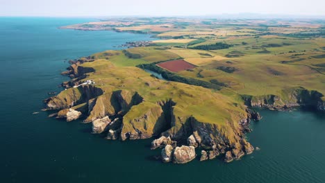 Flyover-the-Scottish-Countryside-Natural-Beauty,-Iconic-Scottish-Landmark-and-Coastal-Village