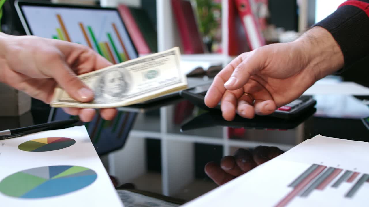 Transfer money cash from hand to hand. Business handshake after money deal