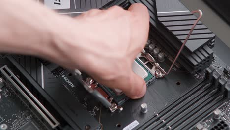 man removing a cpu from a motherboard