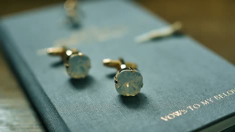 gold cufflinks rotate on a white stand close-up