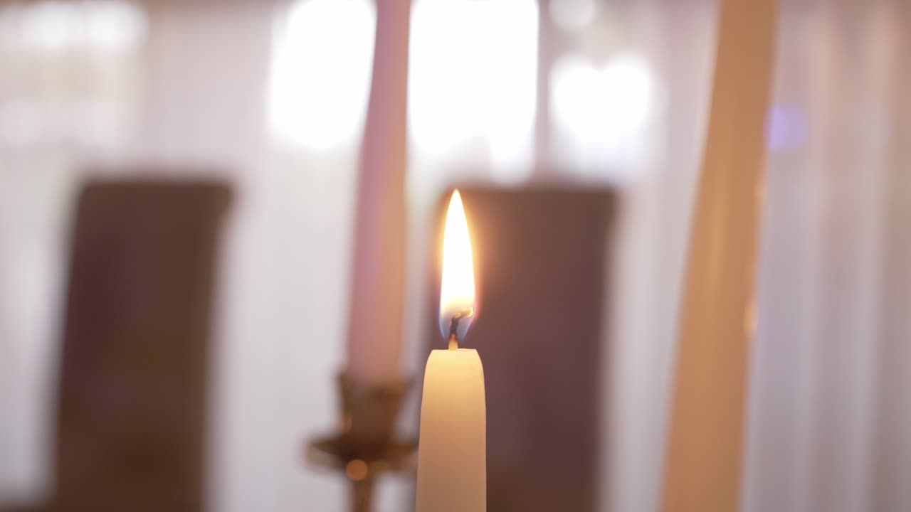 Lit candle with a soft, blurred background creating a calm and warm atmosphere
