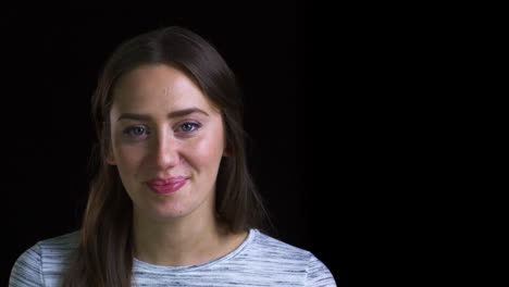 close up of attractive young woman laughing into camera