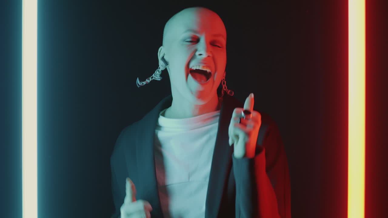 Bald woman singing in neon light