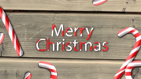 Animation-of-party-candy-against-wooden-background-with-merry-christmas-wish