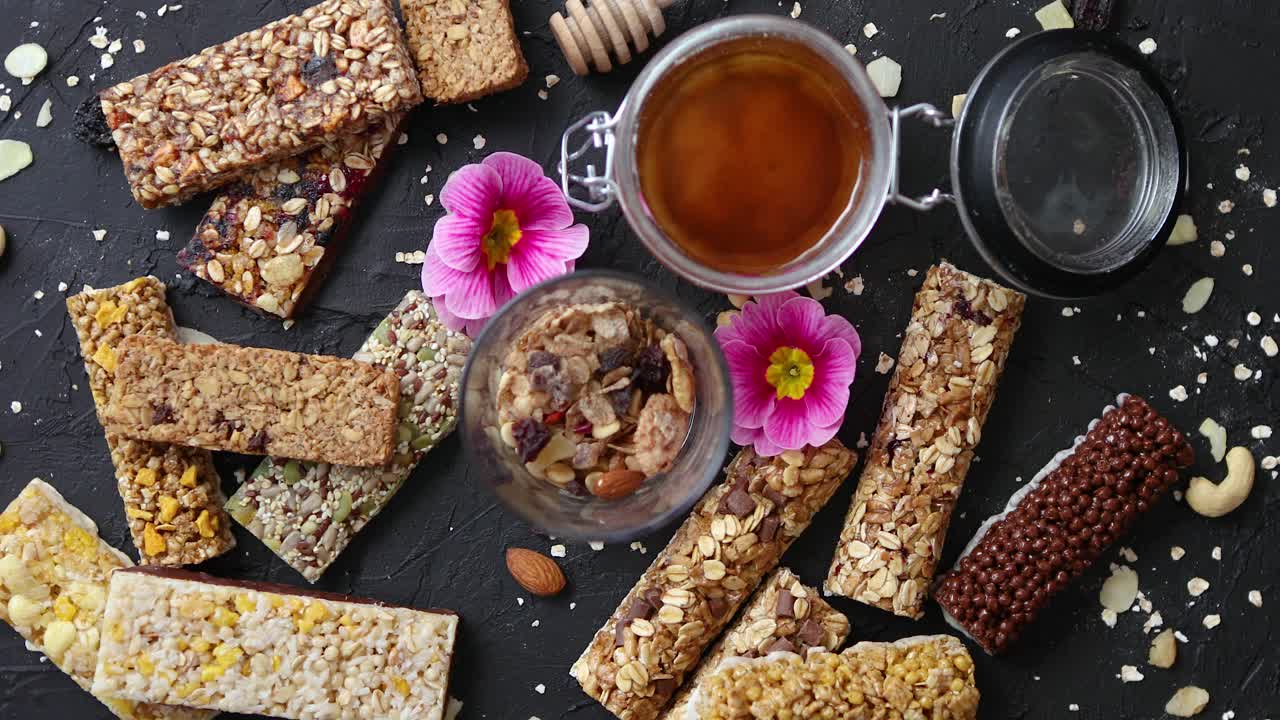 Healthy superfood composition  Various kinds granola energy protein bars with honey in jar