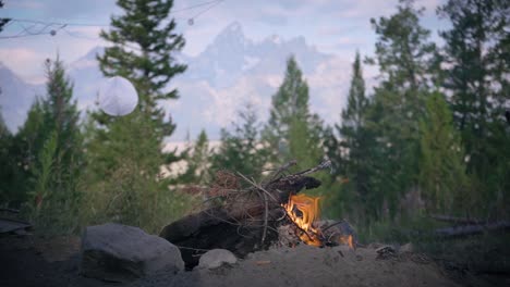 campfire with a beautiful backdrop of the grand teton in wyoming