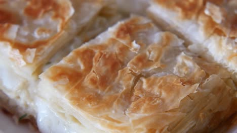 close up of a flaky cheese pastry