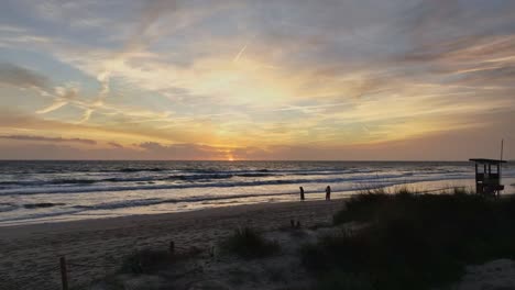 flying drone over sand banks at sunset to reveal scenic landscape
