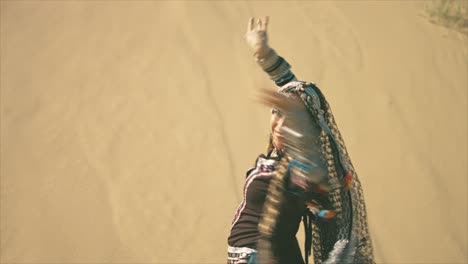 Gypsy-woman-clapping-hands-and-turning-in-the-desert