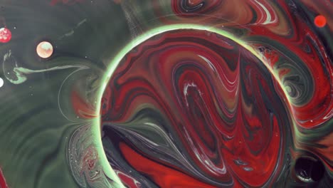 burbujas coloridas. mezcla abstracta de rojo, amarillo y verde sobre un fondo negro. fondo de pintura de color artístico.