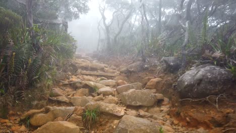 Walking-up-a-foggy,-rocky-mountain