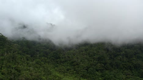 Aerial-truck-right-of-Chirripo-green-dense-forest-hills-and-white-foogy-clouds-passing,-Canaan-de-Rivas,-Costa-Rica