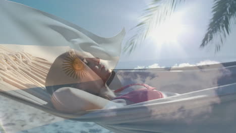 animation of woman relaxing in hammock with argentine flag on sunny beach