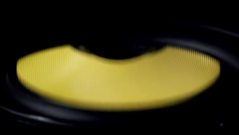 close up at moving sub-woofer. speaker part. black and yellow colors. 4k video