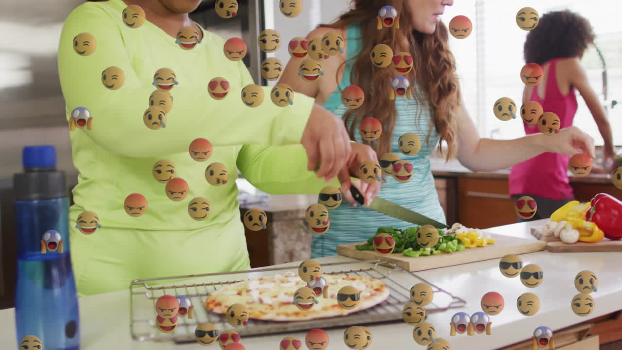 women chopping peppers and washing herbs on kitchen island, featuring animated culinary pizza icons
