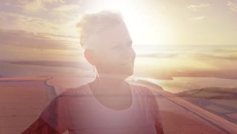 Animation-of-senior-caucasian-woman-with-arms-outstretched-on-beach