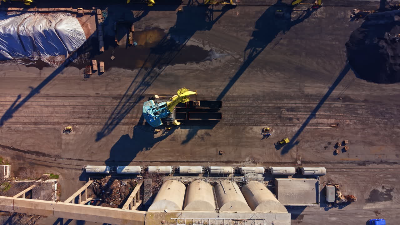 Máquinas Pesadas em Operação em um Canteiro de Obras Durante o Dia, Destacando o Carregamento de Materiais em Caminhões em uma Área Urbana
