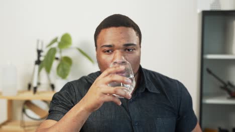 portrait of a dark-skinned man drinking water