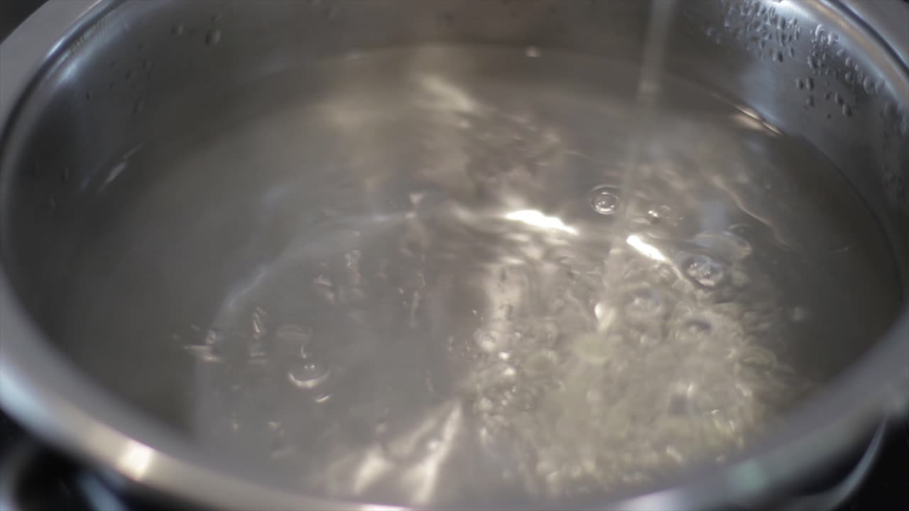 Pouring cooking oil in a pot preparing meal