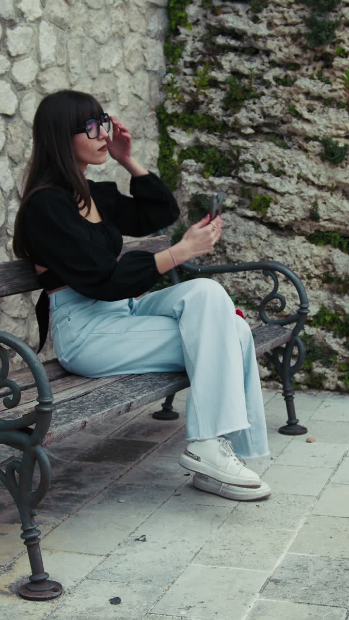 Woman On The Bench Picking Up The Smartphone To Make Some Photos