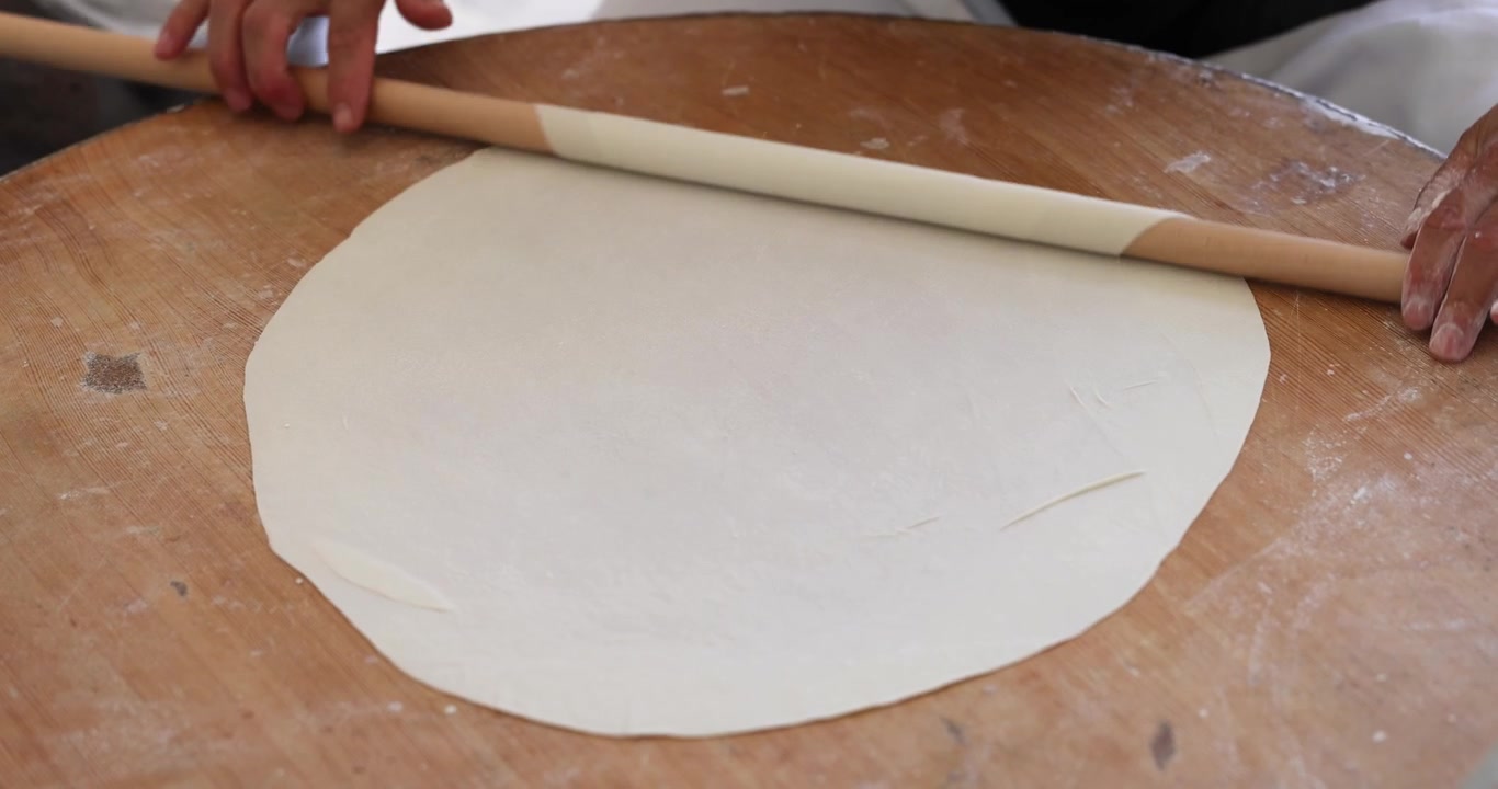 Woman chef rolling out dough for baking tortillas 4k movie