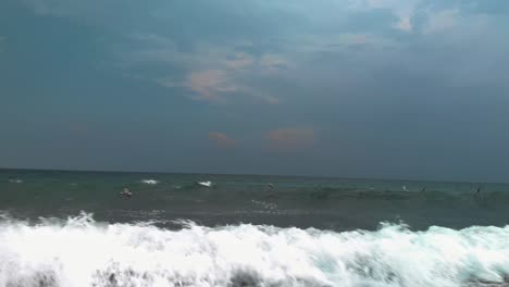 Seagulls-flying-very-close-to-the-sea-waves-in-cloudy-day-in-Sozopol,-Bulgaria