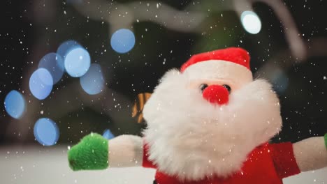 Animation-of-snow-falling-over-christmas-santa-claus-doll
