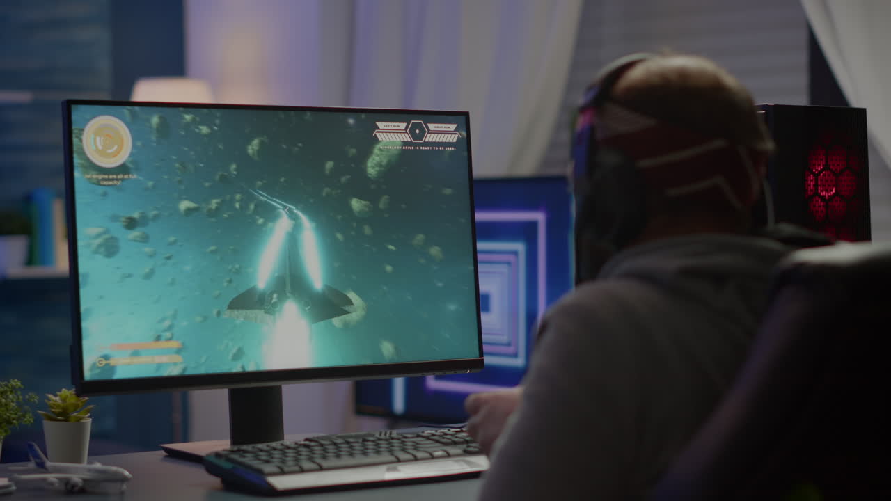 게임 의자 에 앉아 우주 슈팅 비디오 게임 을 하는 승리자 게이머