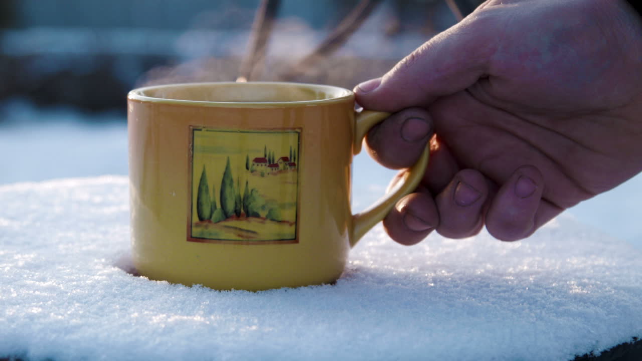 Cup With Hot Tea On a Snow-covered Chair (Stock Footage)