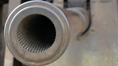 Close-tracking-shot-of-gun-muzzle-from-an-artillery-battery-used-during-world-war-two,-Longues-sur-Mer,-Normandy,-France