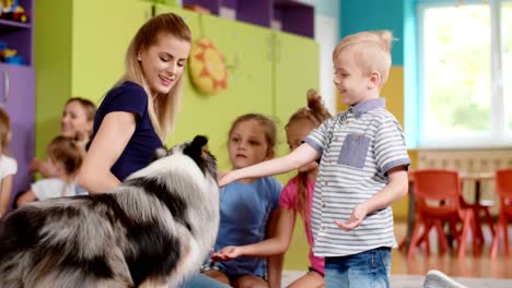 children playing with dog during therapy in the preschool