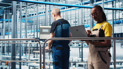 smart factory engineer oversees operation of robotic arms