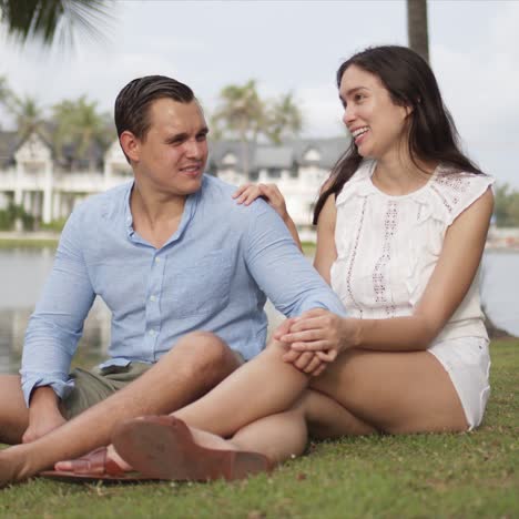 Content-resting-couple-having-rest-on-grass-on-vacation