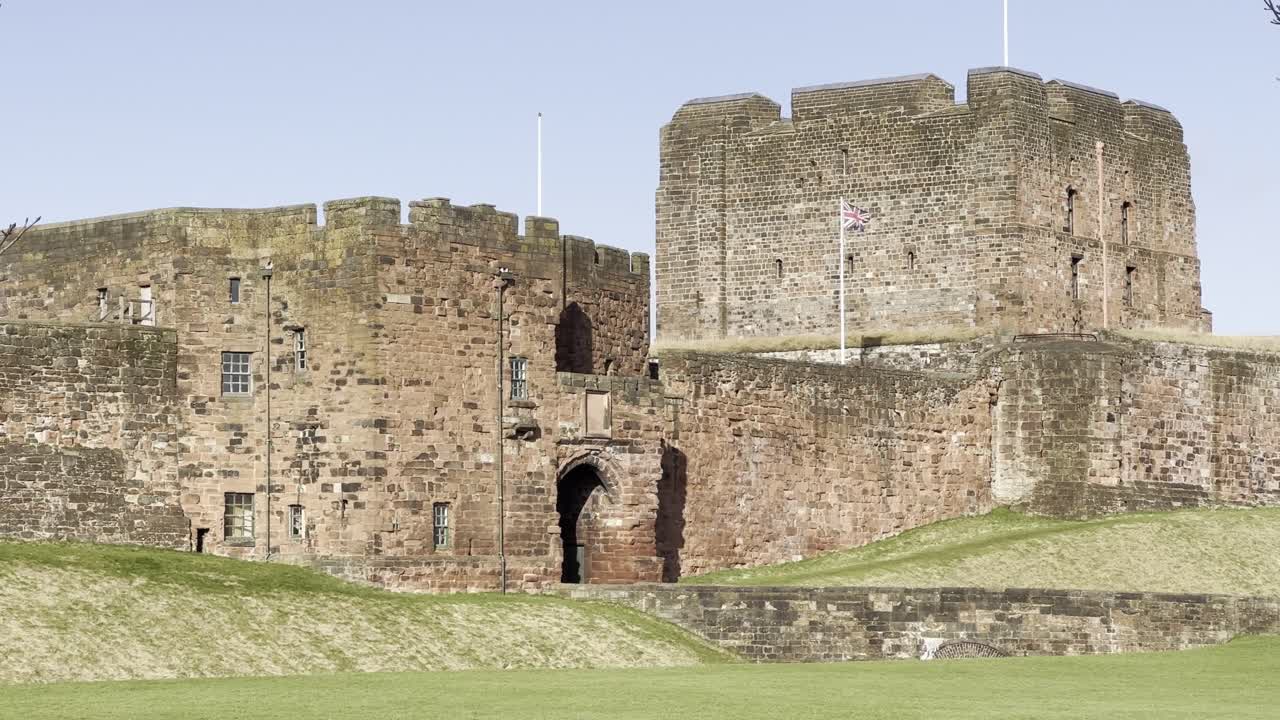 Carlisle Castle front entrance with Union Jack flying proudly on clear, sunny day - Cumbria, England