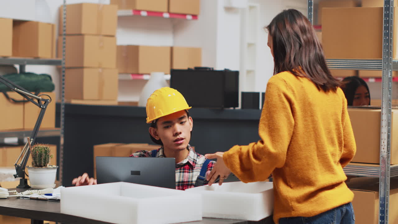 People working in warehouse with boxes