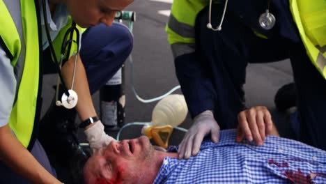 emergency medical technician taking car an injured man