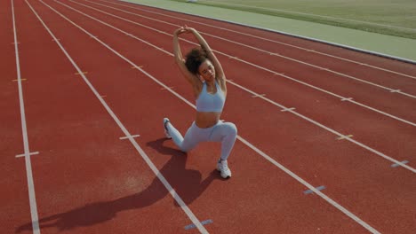 woman stretching on a running track