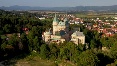 Wide-rotating-drone-shot-of-Bojnice-Castle,-Castle-Of-Spirits,-in-Slovakia