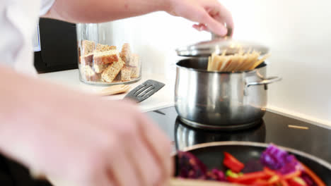 Man-preparing-a-food-in-kitchen