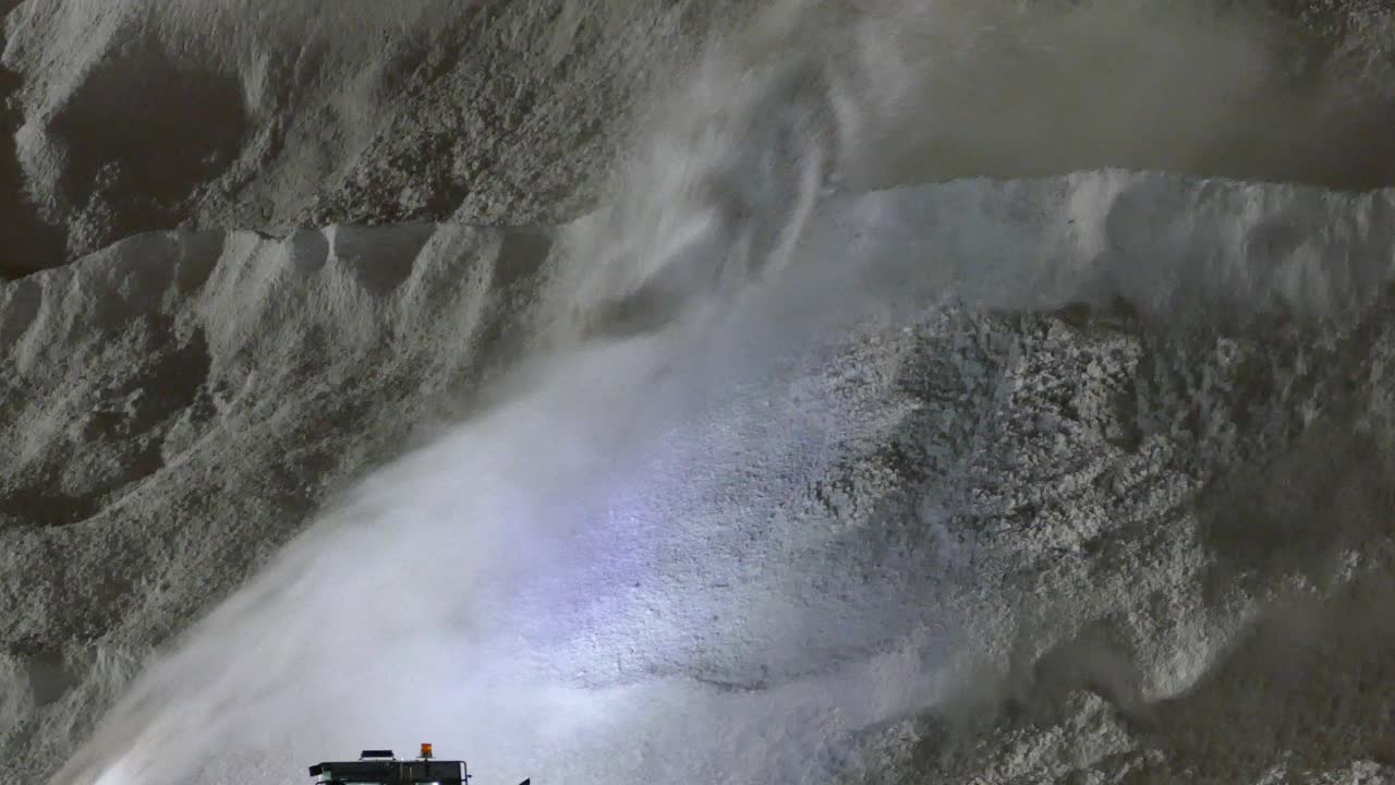 Close up of D87 blower blasting winter snow up onto the huge pile