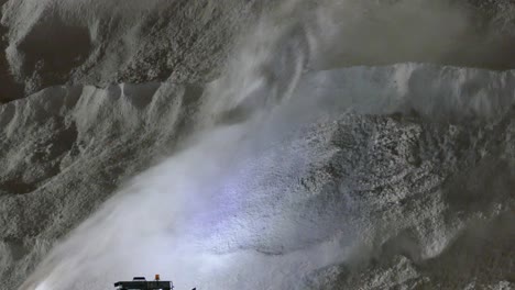 Close-up-of-D87-blower-blasting-winter-snow-up-onto-the-huge-pile