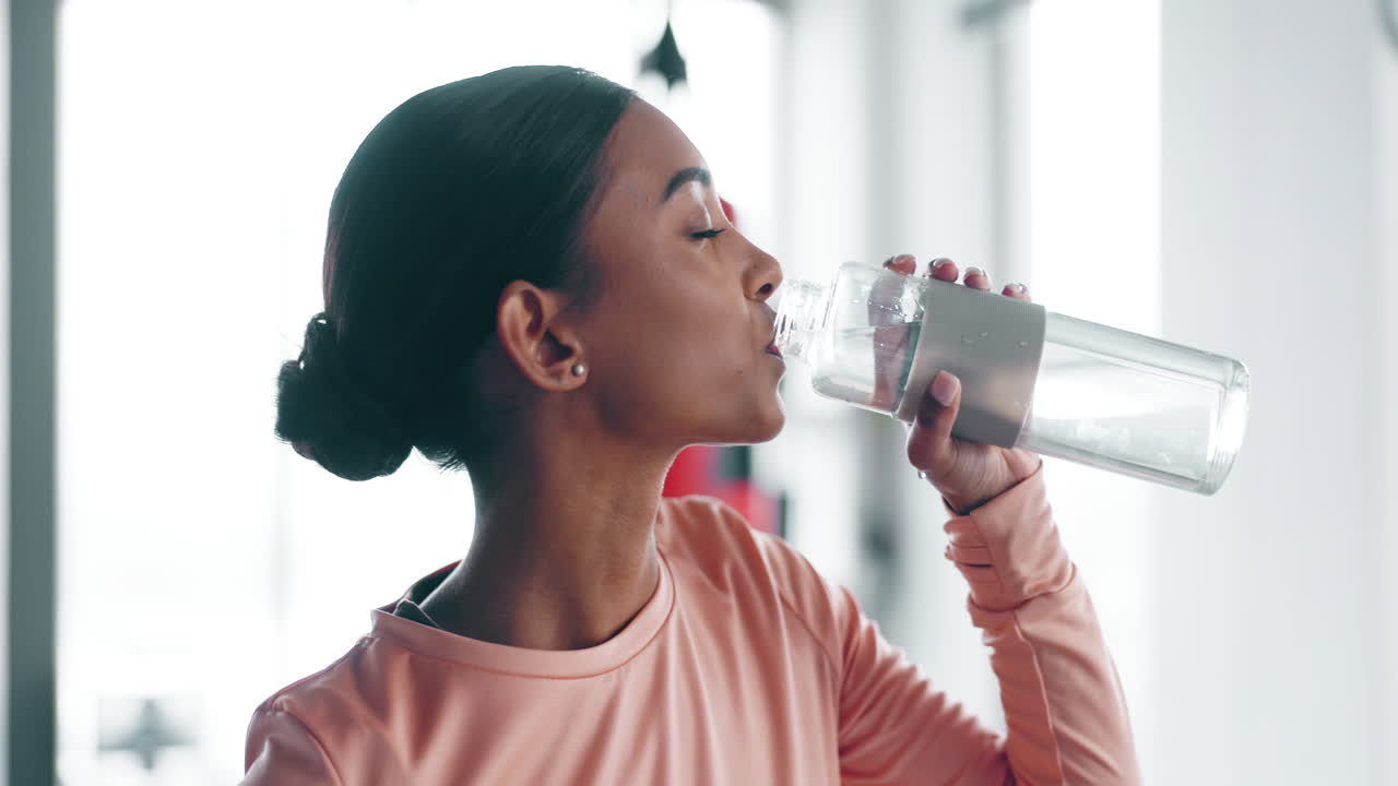 Woman, drinking water and fitness in gym