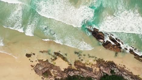 Aerial-view-of-a-summer-seascape-beach,-beautiful-waves,-blue-water-at-sunset