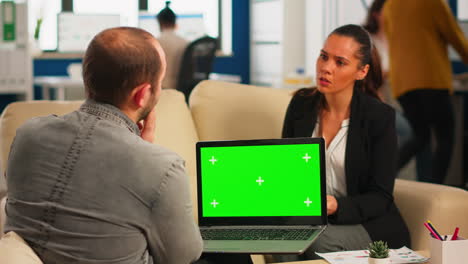 Business-team-sitting-on-couch-analysing-mail-on-laptop-with-mockup-display