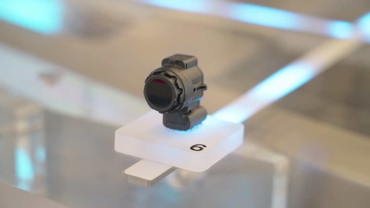 Close-up of an automotive ultrasonic parking sensor displayed on a stand, representing modern vehicle safety technology and advanced driver assistance systems. China