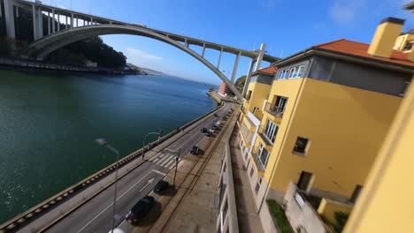 fly by colorful riverside houses by arrabida bridge porto portugal fpv drone