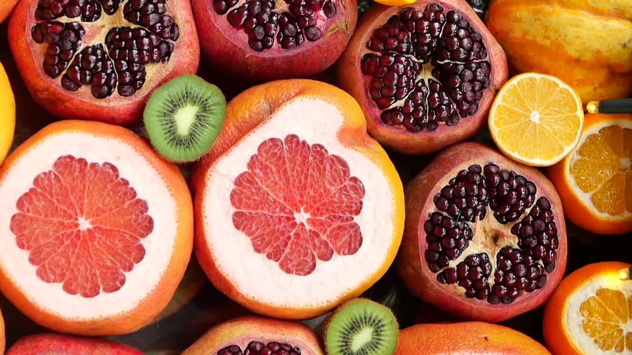 Colorful Assortment of Fresh Cut Citrus and Pomegranate Fruits