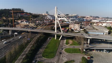 drone flying over a road with traffic in a sunny day in the city of porto