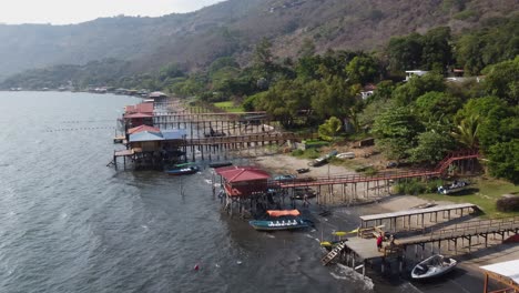 aerial view: restaurants on stilts, volcanic caldera lake, el salvador